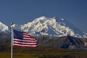 The National Parks are America's best idea. The iconic Denali with our flag. NPS photo by Ken Conger.