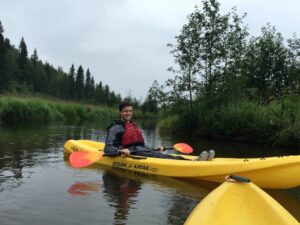 Intern Esack Grueskin kayaking on Byers Lake in Denali State Park.